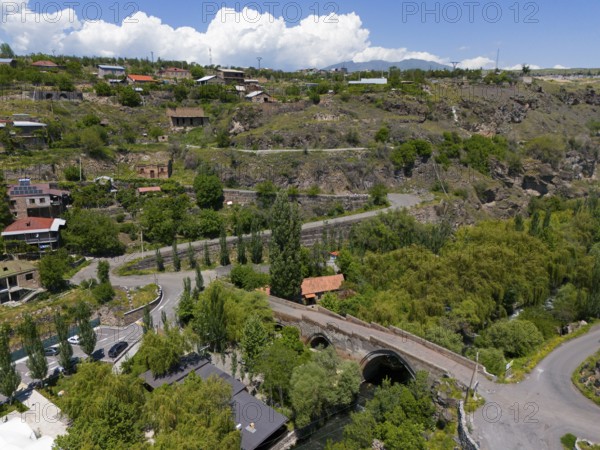 Idyllic village landscape amidst hills, near a river, with clear clouds in the sky, aerial view, Triple arch bridge over the Kassagh river from 1664, Ashtarak bridge, Ashtarak, Aštarak, Aragazotn province, Armenia