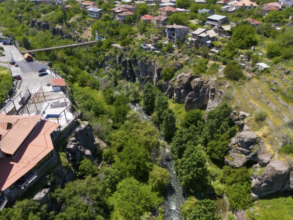 River flowing through a rocky landscape lined with houses and lush vegetation, aerial view, Kassagh River, Ashtarak, Ashtarak, Aštarak, Aragazotn Province, Armenia