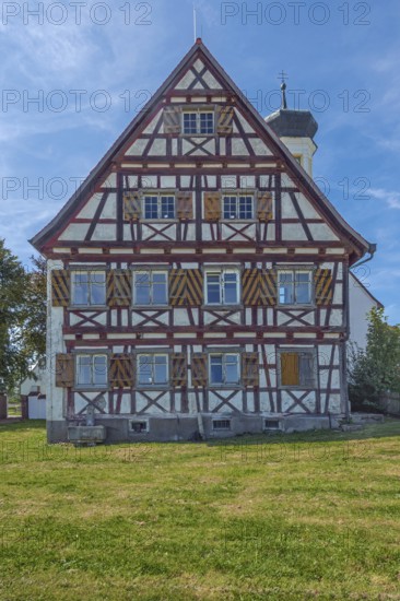 Pointed gable façade with half-timbering next to the hospital chapel in Bärenweiler from 1619 near Kisslegg, Allgäu, Baden-Württemberg, Germany