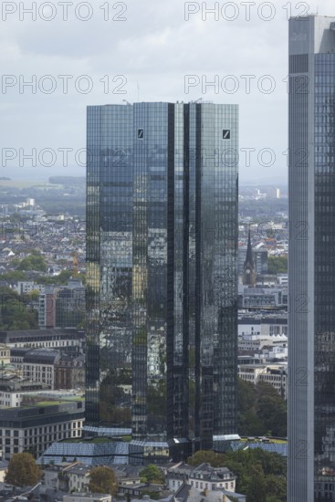 The surroundings of Frankfurt city centre are reflected on the glass façade of the Deutsche Bank Towers, Frankfurt am Main, Hesse, Germany