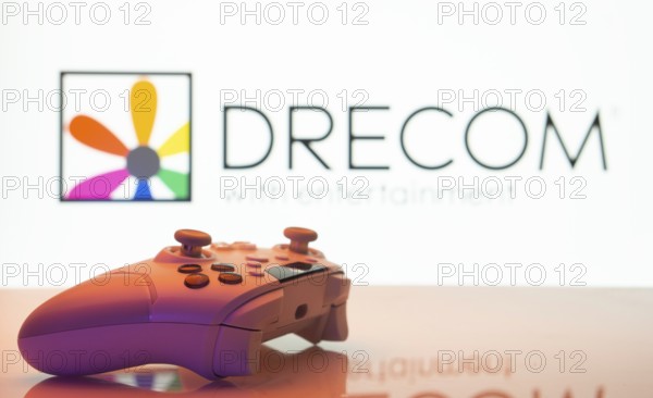 Dhaka, Bangladesh- 13 Sep 2025: A close-up of a white gamepad with the Drecom seen on screen in the background