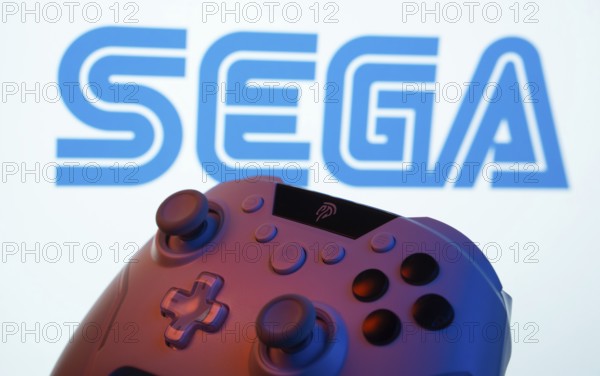 Dhaka, Bangladesh- 13 Sep 2025: A close-up of a gamepad with the Sega seen on screen in the background