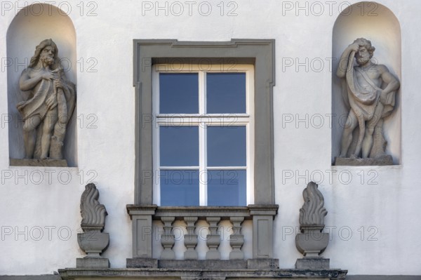 West façade with window and two stone figures, New Castle in Kisslegg, Allgäu, Baden-Württemberg, Germany