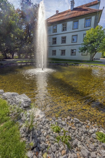 Small pond with water fountain in the castle park in Kisslegg, Allgäu, Baden-Württemberg, Germany