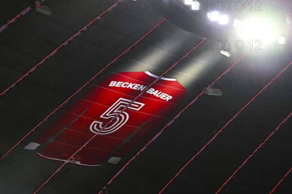 Larger-than-life jersey of Emperor Franz Beckenbauer with shirt number 5 hangs in the grandstand roof of the south curve, 125th anniversary of FC Bayern Munich FCB, radiance, shining figure, Champions League, Allianz Arena, Munich, Bavaria, Germany