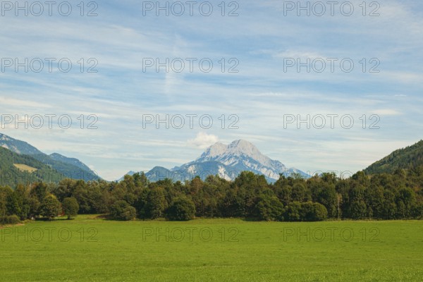 Wide green meadows with mountains in the background under a clear sky, Admont, Styria, Austria
