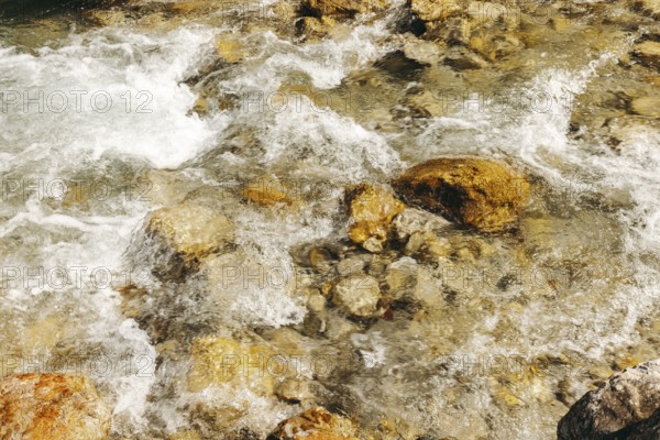 Clear water streams of the Johnsbach flow over rocky stones, Gesäuse, Styria, Austria