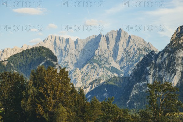 Imposing mountain peaks, Hochtor and Großer Ödstein, rise above wooded hills, Weng im Gesäuse, Styria, Austria
