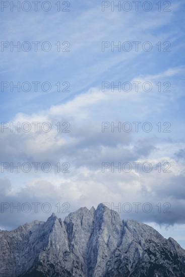 Imposing mountain peak of the Ödstein against a cloudy blue sky, Gesäuse, Styria, Austria