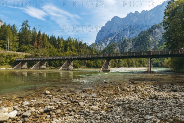 Wooden bridge over the Enns with stony bank and Reichenstein group in the background, Gesäuse, Styria, Austria