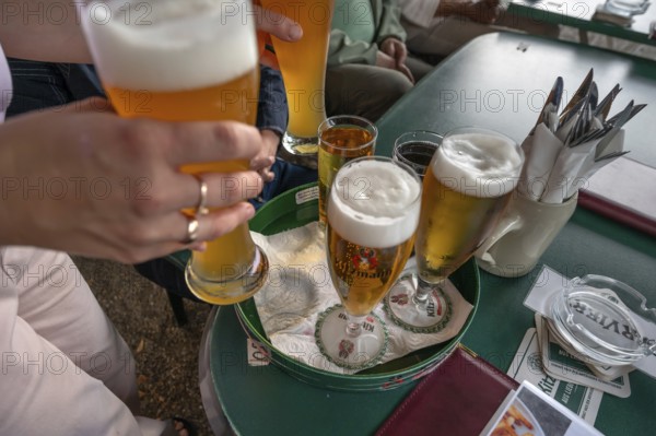 Drinks are served on a tray in a garden restaurant, Franconia, Bavaria, Germany