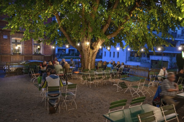 Illuminated garden restaurant in the evening, Erlangen, Middle Franconia, Bavaria, Germany