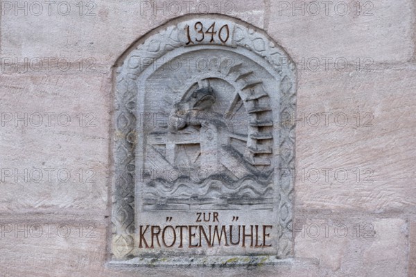 Relief of the former toad mill from 1340 on a house wall on the Pegnitz, Karlsbrücke, Nuremberg Middle Franconia, Bavaria, Germany
