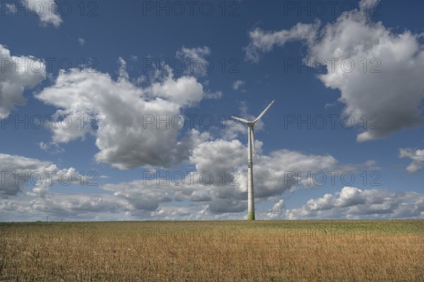 Stubble field, wind turbine and cloudy sky, Karsberg, Upper Franconia, Bavaria, Germany