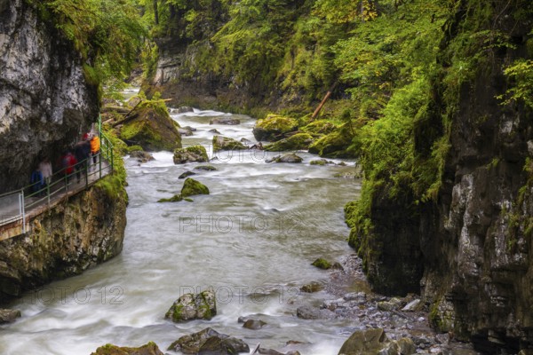 Breitach flows through a narrow gorge with stones, stream, Schrattenkalk, visitors on footbridge, Breitachklamm, Oberstdorf, Allgäu Alps, Bavaria, Germany