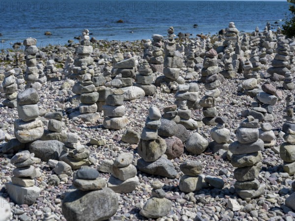 Piled stones on the shore of the island of Stora grundet on the northern tip of the Swedish island of Öland in the Baltic Sea, Öland, Sweden