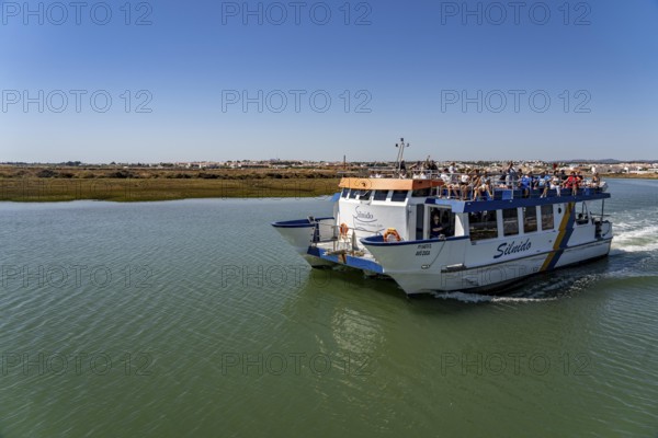 Ride on the Silnido ferry from Tavira on the Gilão River to the beach Praia da Ilha de Tavira, on the island off Tavira, Algarve, Portugal