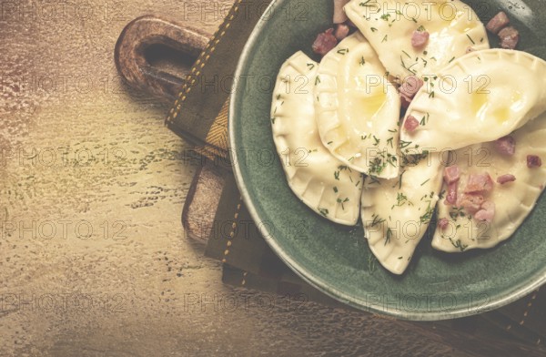 Dumplings, with fried prosciutto, a traditional dish of Polish cuisine, dumplings, top view, close-up, without people