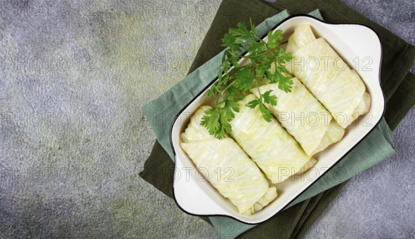 Raw cabbage rolls, not cooked, with minced meat, top view, without people, in the spotlight