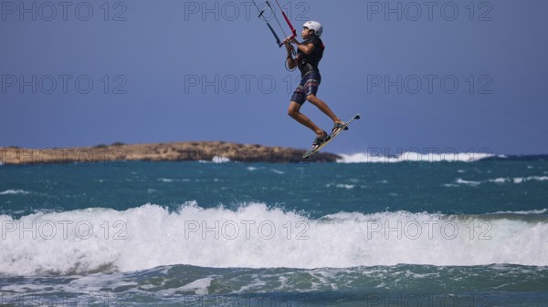 Kitesurfer in the air jumping over the waves in sunny weather, Prasonisi, beach, surf, windsurfer, kite surfer, waves, south coast, Rhodes, Dodecanese, Greek Islands, Greece