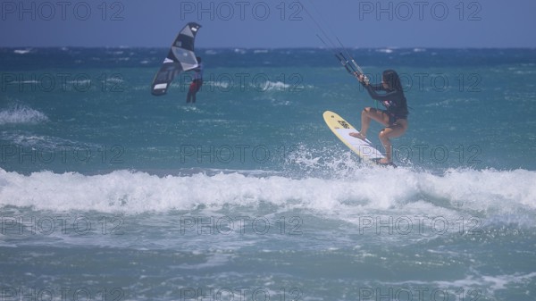Kitesurfer dynamically jumping over a wave on the open sea, Prasonisi, beach, surf, windsurfer, kite surfer, waves, south coast, Rhodes, Dodecanese, Greek Islands, Greece