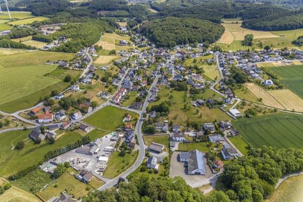 Aerial view, local view district Beckum, catholic church St. Nikolaus, Balve, Sauerland, North Rhine-Westphalia, Germany, place of worship, federal road B229, DE, Europe, religious community, place of worship, property tax, real estate, church, parish, denomination, aerial view, aerial photography, aerial photography, overview, bird's eye view, forest area, living and life, residential area, residential buildings, residential quality, housing estate, birds-eyes view, overview