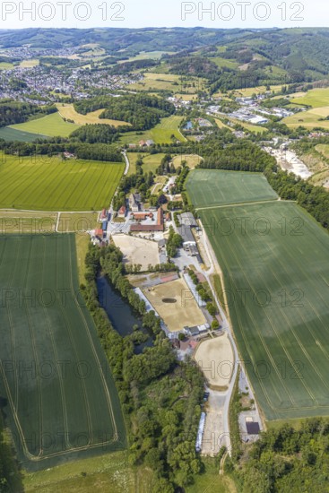 Aerial view, equestrian centre Reiterverein Balve, Schloss Wocklum, Balve, Sauerland, North Rhine-Westphalia, Germany, DE, Europe, manor house, manor house, manor building, courtyard, aerial view, aerial photography, aerial photography, horses, equestrian sports, equestrian centre, riding stable, riding club, riding stable, castle, castle garden, overview, defence system, bird's eye view, forest area, moated castle, moated castle, meadows and fields, Wocklum, birds-eyes view, overview