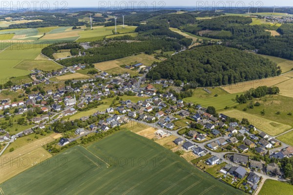 Aerial view, local view district Beckum, building area new construction single-family houses, catholic church St. Nikolaus, Balve, Sauerland, North Rhine-Westphalia, Germany, place of worship, DE, Europe, religious community, place of worship, property tax, real estate, church, parish, denomination, aerial view, aerial photography, aerial photography, Roussayer Weg, overview, bird's-eye view, wooded area, meadows and fields, living and life, residential area, residential buildings, quality of life, housing estate, Zum Langenloh, birds-eyes view, overview