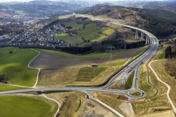 Aerial view, valley bridge Nuttlar, motorway A46, view of Nuttlar, junction B480n, hilly landscape, Bestwig, North Rhine-Westphalia, Germany, motorway A46 extension, motorway bridge, bridge, federal road B480n, DE, Europe, roundabout, aerial view, aerial photography, aerial photography, Nuttlar, Rüthener Straße, Sauerland, valley bridge, overview, bird's-eye view, forest area, birds-eyes view, overview
