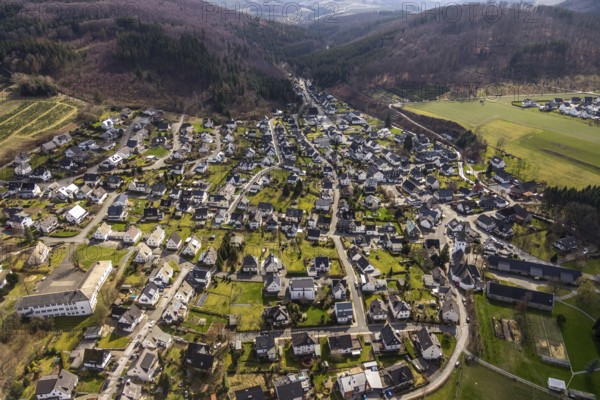Aerial view, view of Ostwig, St. Joseph-Kirche Ostwig, Anne-Frank-Schule Ostwig, Bestwig, North Rhine-Westphalia, Germany, education, educational institution, DE, Europe, half-timbered houses, special school, religious community, place of worship, property tax, hilly landscape, real estate, church, parish, denomination, educational institute, aerial view, aerial photography, aerial photography, religion, school, overview, bird's-eye view, wooded area, residential area, housing and living, residential area, residential buildings, housing estate, birds-eyes view, overview