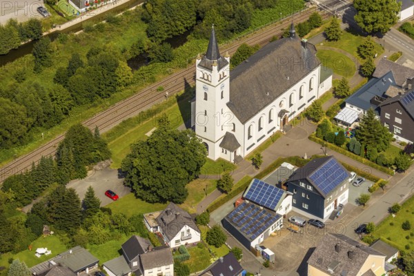 Aerial view, St. Andrew's Catholic Church, EKI-Therm company building with solar panel, Velmede, Bestwig, Sauerland, North Rhine-Westphalia, Germany, An der Andreaskirche, place of worship, railway tracks, DE, Europe, religious community, place of worship, church, parish, denomination, aerial view, aerial photography, aerial photography, photovoltaics, photovoltaic system, religion, solar, solar system, solar energy, solar power, overview, bird's-eye view, birds-eyes view, overview