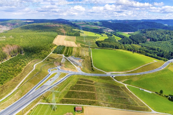 Aerial view, motorway A46, Nuttlar junction B480n, view towards Brilon, further construction of the motorway A46, hilly landscape, Bestwig, North Rhine-Westphalia, Germany, motorway A46 extension, construction work, construction area, construction site, construction measure, construction project, construction site, federal road B480n, DE, Europe, roundabout, aerial view, aerial photography, aerial photography, new construction, Nuttlar, Sauerland, overview, bird's eye view, forest area, meadows and fields, birds-eyes view, overview