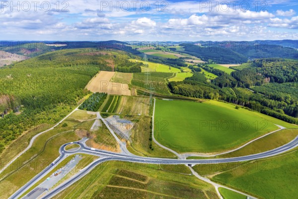 Aerial view, motorway A46, Nuttlar junction B480n, view towards Brilon, further construction of the motorway A46, hilly landscape, Bestwig, North Rhine-Westphalia, Germany, motorway A46 extension, construction work, construction area, construction site, construction measure, construction project, construction site, federal road B480n, DE, Europe, roundabout, aerial view, aerial photography, aerial photography, new construction, Nuttlar, Sauerland, overview, bird's eye view, forest area, meadows and fields, birds-eyes view, overview