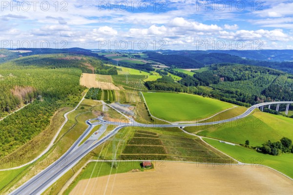Aerial view, motorway A46, Nuttlar junction B480n, view towards Brilon, further construction of the motorway A46, hilly landscape, Bestwig, North Rhine-Westphalia, Germany, motorway A46 extension, construction work, construction area, construction site, construction measure, construction project, construction site, federal road B480n, DE, Europe, roundabout, aerial view, aerial photography, aerial photography, new construction, Nuttlar, Sauerland, overview, bird's eye view, forest area, meadows and fields, birds-eyes view, overview