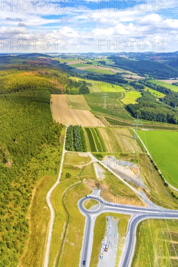 Aerial view, motorway A46, Nuttlar junction B480n, hilly landscape, Bestwig, North Rhine-Westphalia, Germany, motorway A46 extension, construction work, construction area, construction site, construction measure, construction project, construction site, federal road B480n, DE, Europe, roundabout, aerial view, aerial photography, aerial photography, new construction, Nuttlar, Sauerland, overview, bird's eye view, forest area, meadows and fields, birds-eyes view, overview