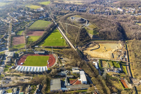 Aerial photograph, Lohrheide stadium, Rheinelbe spoil tip, construction site rainwater retention basin Wattenscheider Bach, Leithe, Bochum, Ruhr area, North Rhine-Westphalia, Germany, construction work, construction area, construction project, mining, spoil tip, DE, Europe, football pitch, football stadium, football club, Gelsenkirchen, spoil tip, landmark, landscape forms, landscape park, Leithestraße, Lohrheide, aerial view, aerial photography, aerial photography, Olympic training centre Ruhr-Ost, route industrial heritage, pointed cone, sports, sports facilities, sports field, sports field Espenloh, sports facility, stadium, table mountain, overview, bird's-eye view, birds-eyes view, former Rheinelbe colliery, overview