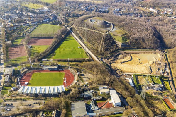 Aerial photograph, Lohrheide stadium, Rheinelbe spoil tip, construction site rainwater retention basin Wattenscheider Bach, Leithe, Bochum, Ruhr area, North Rhine-Westphalia, Germany, construction work, construction area, construction project, mining, spoil tip, DE, Europe, football pitch, football stadium, football club, Gelsenkirchen, spoil tip, landmark, landscape forms, landscape park, Leithestraße, Lohrheide, aerial view, aerial photography, aerial photography, Olympic training centre Ruhr-Ost, route industrial heritage, pointed cone, sports, sports facilities, sports field, sports field Espenloh, sports facility, stadium, table mountain, overview, bird's-eye view, birds-eyes view, former Rheinelbe colliery, overview