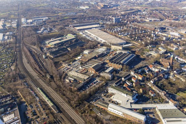 Aerial view, Heintzmann-Werke, Bessemer Straße, Kruppwerke, Bochum, Ruhr area, North Rhine-Westphalia, Germany, railway tracks, railway station, Bessemer Straße, Bochum-Ehrenfeld, DE, DSV Stuttgart GmbH LKW Spedition, Deutsche Bahn AG, commercial space, commercial area, commercial use, Heintzmann Holding GmbH, industrial plants, industrial site, aerial view, aerial photography, aerial photography, production plants, production halls, S-Bahn, S-Bahn station, overview, bird's-eye view, birds-eyes view, overview