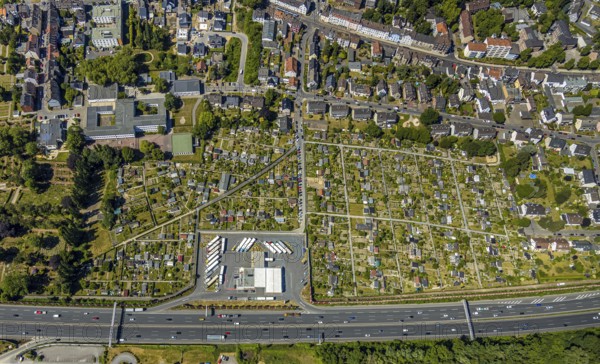 Aerial view, Shell petrol station, Vietingstraße, truck parking, motorway A40, allotment garden site Centrum Morgensonne, KGV am Dückerweg, Bochum-Wattenscheid, Ruhr area, North Rhine-Westphalia, Germany, DE, Europe, shapes and colours, community garden, freight transport, freight traffic, KGV, allotment garden, allotment garden site, allotment garden association, allotment gardener association, aerial view, aerial photography, aerial photography, car parks, passenger traffic, allotment garden, road traffic, petrol station, overview, traffic volume, bird's-eye view, overview, nature and road traffic, traffic infrastructure, Ruhr expressway
