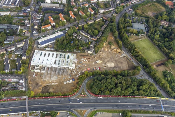 Aerial view, Berliner Straße, planned DIY store with garden centre, motorway A40, junction Wattenscheid-West, sports centre Wattenscheid-West Berliner Straße, Leithe, Bochum, Ruhr area, North Rhine-Westphalia, Germany, construction work, construction area, building site, building plots, construction project, construction site, Bochum-Wattenscheid, DE, Europe, football pitch, football stadium, football club, Klaus-Steilmann-Platz, aerial view, aerial photography, aerial photography, new construction, sports, sports facilities, sports community 09 Wattenscheid, sports field, sports facility, Wattenscheid district, overview, bird's-eye view, Wattenscheid, birds-eyes view, planned construction market, overview