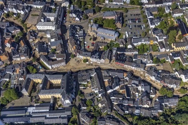 Aerial view, historic old town with St. Donatus-Jesuit church and St. Michael-Gymnasium as well as collegiate church St. Chrysanthus and Daria and Bad Münstereifel town hall with destroyed bank area of the Erft after the Erft flood in Bad Münstereifel, Ahr flood, Ahr valley, North Rhine-Westphalia, Germany, place of worship, Bad Münstereifel, authority, education, educational institution, DE, Europe, flood disaster, religious community, place of worship, property tax, grammar school, holy place, flood disaster, real estate, flood of the century, church, parish, denomination, teaching institute, aerial view, aerial photography, aerial photography, town hall, religion, religious site, school, heavy rain, overview, bird's-eye view, living and life, residential area, residential buildings, quality of life, birds-eyes view, overview, flooding