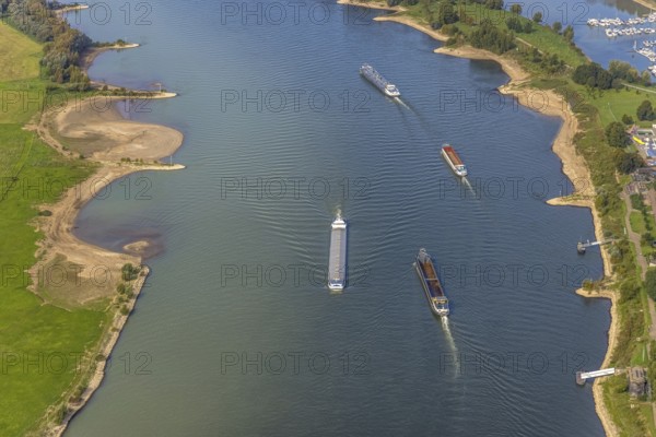 Aerial view, inland navigation on the river Rhine in the district Büderich in Wesel, Lower Rhine, North Rhine-Westphalia, Germany, inland navigation, DE, Europe, goods transport, goods traffic, cargo ships, aerial view, aerial photography, aerial photography, renaturalisation of the Lippe estuary, shipping traffic, overview, riverbank area, bird's eye view, Wesel, birds-eyes view, overview