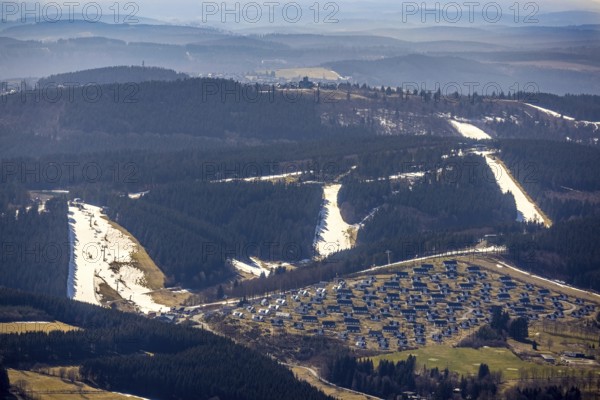 Landal Ferienpark Winterberg, Winterberg, Sauerland, North Rhine-Westphalia, Germany, DE, Europe, distant view, hilly landscape, aerial view, aerial photograph, aerial photography, aerial photography, pandemic lockdown, terraced houses, snow remains, overview, bird's eye view, forest area, winter, residential complex, residential park, housing estate, birds-eyes view, overview