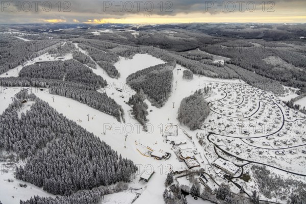 Aerial view of the snowy winter landscape of Winterberg with deserted ski lifts and slopes during the corona-related lockdown in the Sauerland in North Rhine-Westphalia, Germany, Sauerland, Europe, aerial photo, birds-eyes view, aerial photography, aerial photography, overview, bird's eye view, lockdown, closed winter landscape, corona lockdown, deserted, snow, winter weather, corona-related lockdown