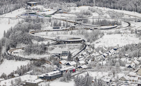 Aerial view of the snowy winter landscape of Winterberg with the VELTINS-EisArena Winterberg bobsleigh run in Sauerland in North Rhine-Westphalia, Germany, Sauerland, Europe, aerial photo, birds-eyes view, aerial photography, aerial photography, overview, bird's eye view, lockdown, closed winter landscape, corona lockdown, deserted, snow, winter weather, corona-related lockdown