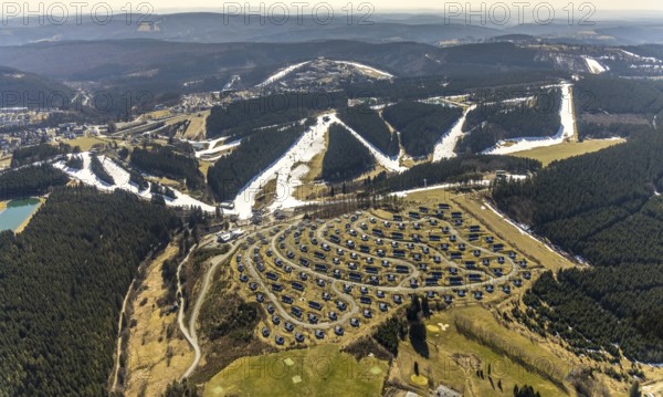 Landal Ferienpark Winterberg, Winterberg, Sauerland, North Rhine-Westphalia, Germany, DE, Europe, distant view, hilly landscape, aerial view, aerial photograph, aerial photography, aerial photography, pandemic lockdown, terraced houses, snow remains, overview, bird's eye view, forest area, winter, residential complex, residential park, housing estate, birds-eyes view, overview