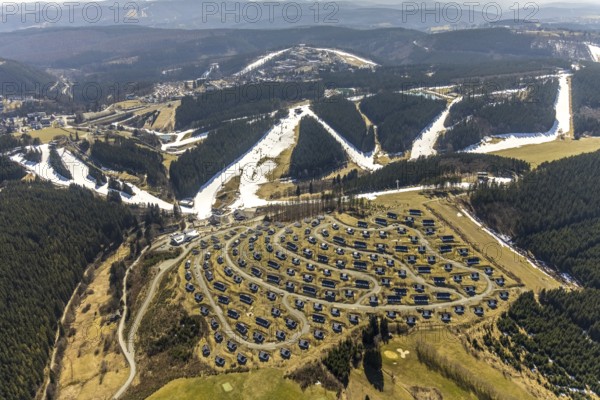 Landal Ferienpark Winterberg, Winterberg, Sauerland, North Rhine-Westphalia, Germany, DE, Europe, distant view, hilly landscape, aerial view, aerial photograph, aerial photography, aerial photography, pandemic lockdown, terraced houses, snow remains, overview, bird's eye view, forest area, winter, residential complex, residential park, housing estate, birds-eyes view, overview