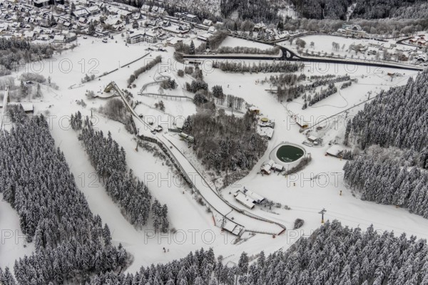 Aerial view of the snowy winter landscape of Winterberg with the St. Georg ski jump in the Sauerland in North Rhine-Westphalia, Germany, Sauerland, Europe, aerial photo, birds-eyes view, aerial photography, aerial photography, overview, bird's eye view, lockdown, closed winter landscape, corona lockdown, deserted, snow, winter weather, corona-related lockdown