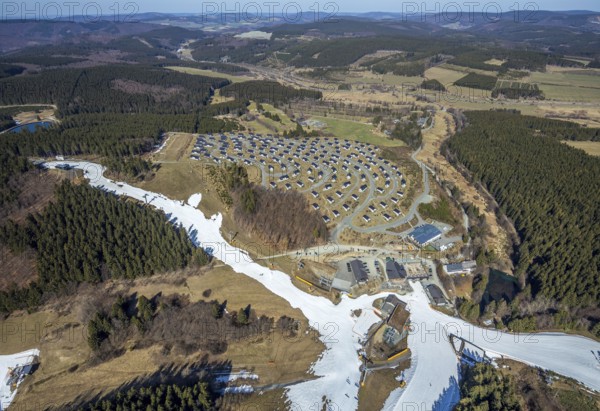 Landal Ferienpark Winterberg, Winterberg, Sauerland, North Rhine-Westphalia, Germany, DE, Europe, distant view, hilly landscape, aerial view, aerial photograph, aerial photography, aerial photography, pandemic lockdown, terraced houses, snow remains, overview, bird's eye view, forest area, winter, residential complex, residential park, housing estate, birds-eyes view, overview