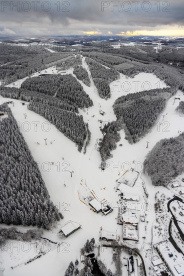Aerial view of the snowy winter landscape of Winterberg with deserted ski lifts and slopes during the corona-related lockdown in Sauerland in North Rhine-Westphalia, Germany, Sauerland, Europe, aerial photo, birds-eyes view, aerial photography, aerial photography, overview, bird's eye view, lockdown, closed winter landscape, corona lockdown, deserted, snow, winter weather, corona-related lockdown